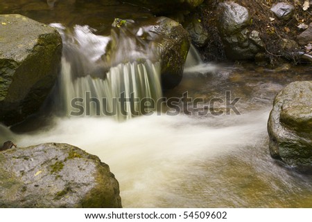 Rocky, stony river with a waterfall.