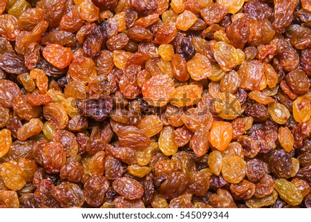 Golden Raisins background, texture Royalty-Free Stock Photo #545099344