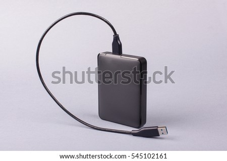 External 2.5'' hard drive HDD isolated on the gray background Royalty-Free Stock Photo #545102161