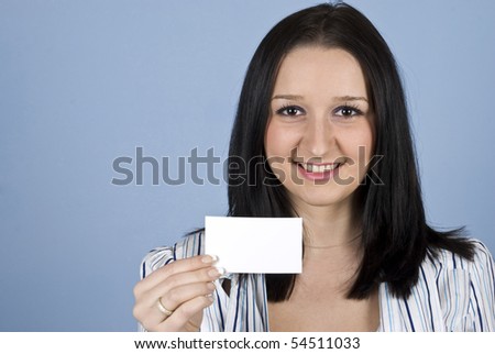 Young business woman showing a blank business card on blue background