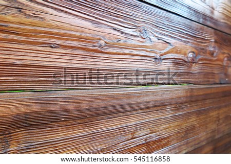 Textured and brown lacquered pine boards of a modern garden shed