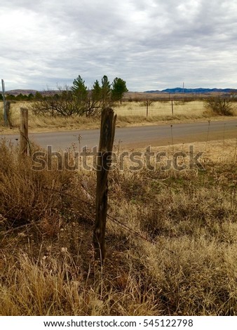 Fence Post on Rural Desert Road in West Texas on a Cloudy Winter Day