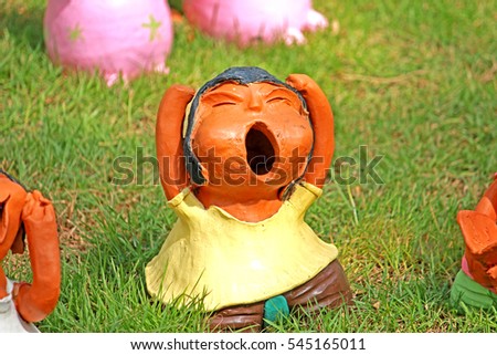 Decorative clay doll in the garden