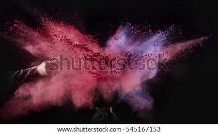 Color powder exploded, isolated on control environment.