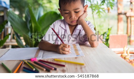 cute young boy doing homework