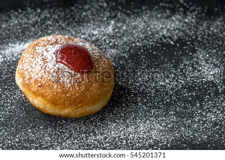 Sufganiyah
A sufganiyah is a round jelly doughnut eaten in Israel and around the world on the Jewish festival of Hanukkah. The doughnut is deep-fried, filled with jelly or custard.