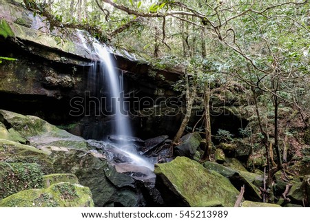 Waterfall, stream and rocks in the jungle.