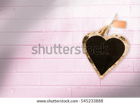 Heart shape black board on pink cement wall, valentines' day background