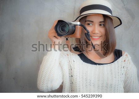 Happy smiling pretty girl taking photo picture with camera. Attractive gorgeous young retro woman photographing.
