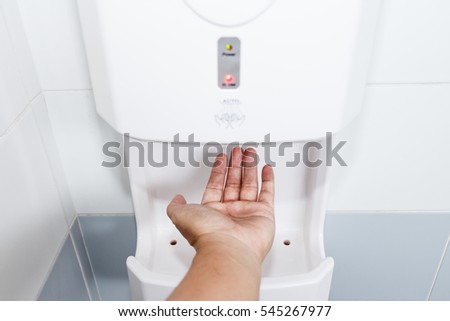 Hand Air Dryer In Public Toilet or Washrooms.Selective focus