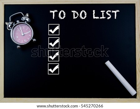 To Do List word with clock on table in front of chalkboard