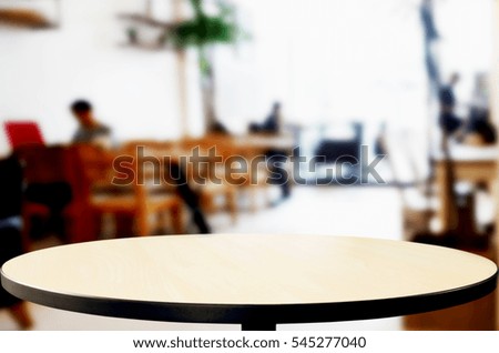 Selected focus empty brown wooden table and Coffee shop or restaurent blur background with bokeh image. for your photomontage or product display.