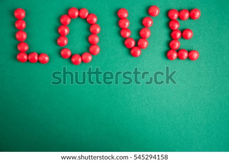 Red candy Heart shape and lettering over black background