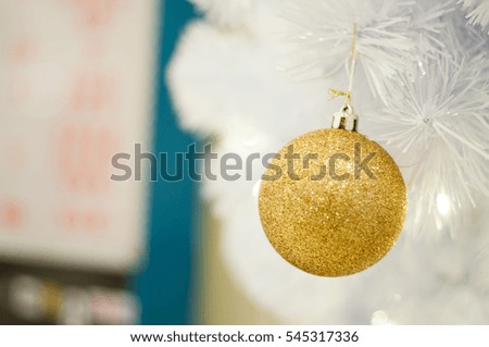 Christmas decoration beautiful golden ball on white tree with blur background