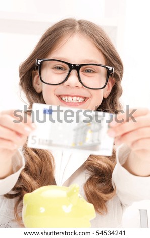 picture of little girl with piggy bank and money