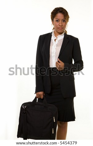 Attractive young curly hair brunette Hispanic American woman wearing business jacket and skirt carrying a black briefcase standing on white