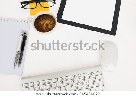 Digital tablet touch pad computer with keyboard, mouse and coffee in office table business