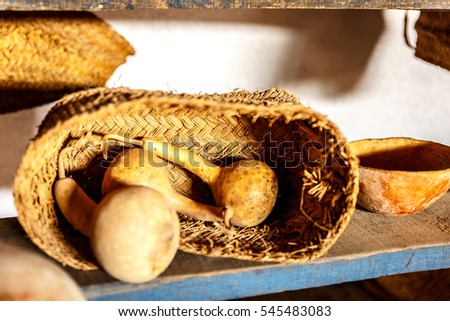 Wicker basket with dried vegetables on a wooden plank