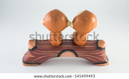 carved wooden dolls/two monkeys sitting on bench