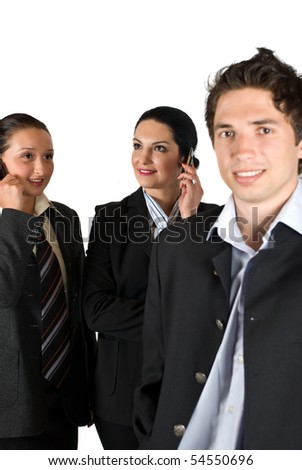 A group of three business people with two happy  businesswoman talking on phone mobile  in background,focus on them and smiling businessman right corner in front of photo
