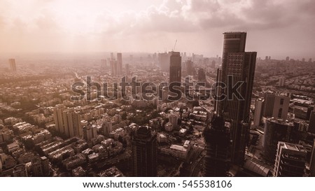 Aerial view of tel aviv skyline with urban skyscrapers at sunset, with cloudy sky, Israel