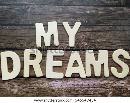 My dreams. Dream wooden letters on wooden background. 