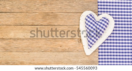 Blue heart on wooden background.