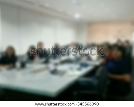 blur image of colleagues sitting in the conference room looking at the presentation