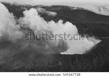 Artistic black and white volcano erupting