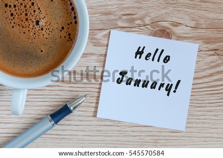Hello January greeting on paper at home or office workplace, near morning cup of coffee. business background