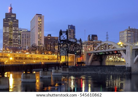 Twilight City Lights in St Paul with Car and Rail Traffic Bridges over the Mississippi River in the Foreground