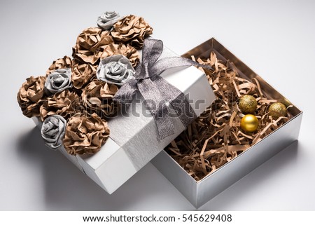 Christmas gift box decoration on white background. Golden silver present box. Close up 