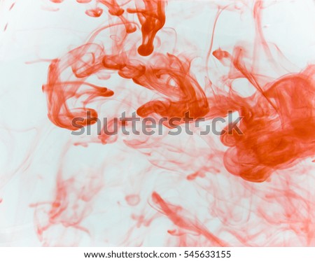 Ink drops, red, in water