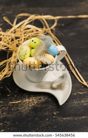 Table setting for Easter dinner with eggs on dark wooden table
