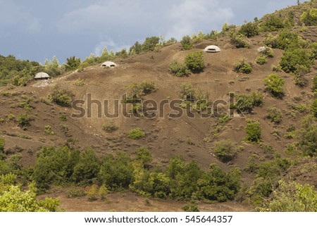 Albanian landscape with concrete bunkers in the mountains