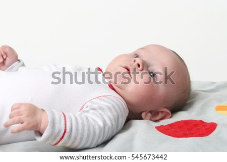 Happy baby newborn lying on the back on white background