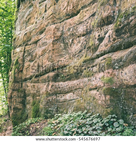sandstone cliffs with inscriptions near tourist trails - instant vintage square photo