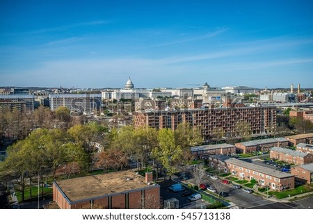 A view of America Capital Washington DC from a rooftop showing both historical and modern buildings under blue sky