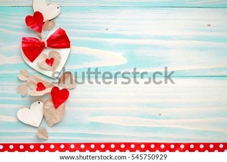 Happy Valentines day photo card background. Blue wooden table and natural material hearts with red bows hipsters background birthday women's day party
celebrations decor objects cute polka dots ribbon