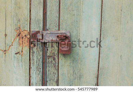 Old key on old wooden background.