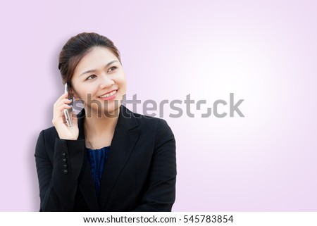 Portrait of smiling business woman using phone on pink background with copy space