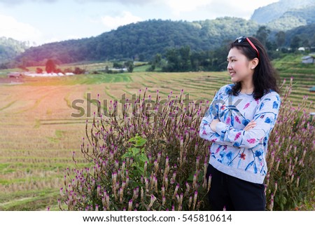Portrait asian woman happy on cornfield and mountain in thailand background.