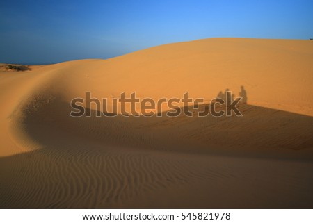 Beautiful landscape with clear sky and white sand on the desert with shadow people in the morning -mui ne, vietnam (May, 2009)