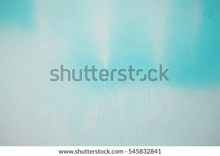 Blue concrete wall with white paint spots