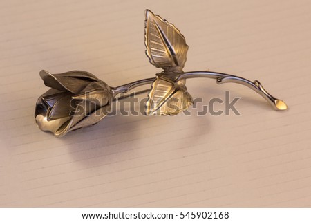 Metal rose on a background for holiday greetings