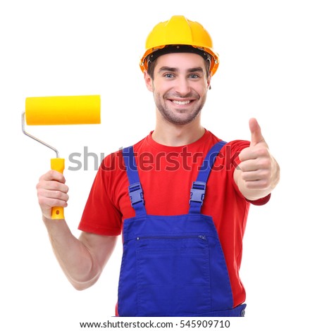 Handsome young decorator with paint roller on white background