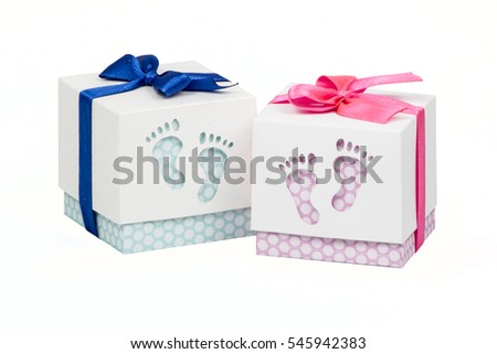 Two small boxes with gift for a newborn baby, pink and blue polka dots, top decorated with bow
