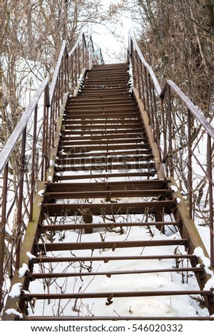 old rusty metal ladder in the snow