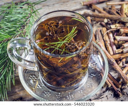 Useful tea from dry branches raspberries and pine needles Royalty-Free Stock Photo #546023320