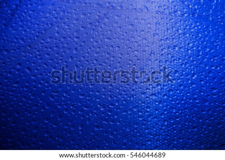 Dew drop and light on blue canvas to background